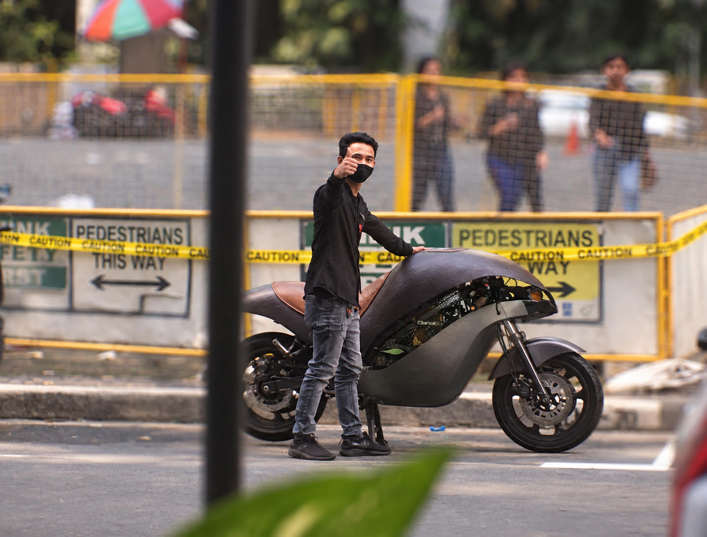 A team member gives a thumbs-up beside the prototype