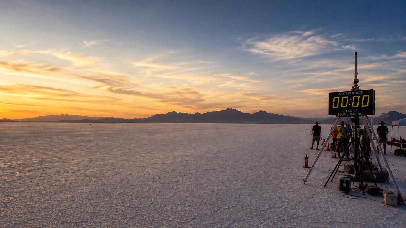 Bonneville salt landscape and timing gate beneath a restrained blue-and-peach sky